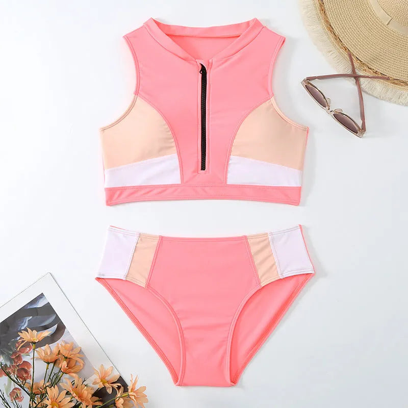 Pink high-waist bikini set with sleeveless top and split-leg shorts on a mannequin.