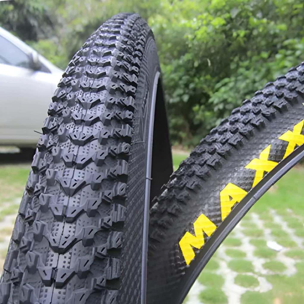 Mountain bike tyre with puncture-proof construction, shown in multiple sizes including 26x1.95 and 27.5x2.1