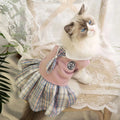 A pink tartan skirt for a small dog, showing the elastic waistband and princess-style flare.