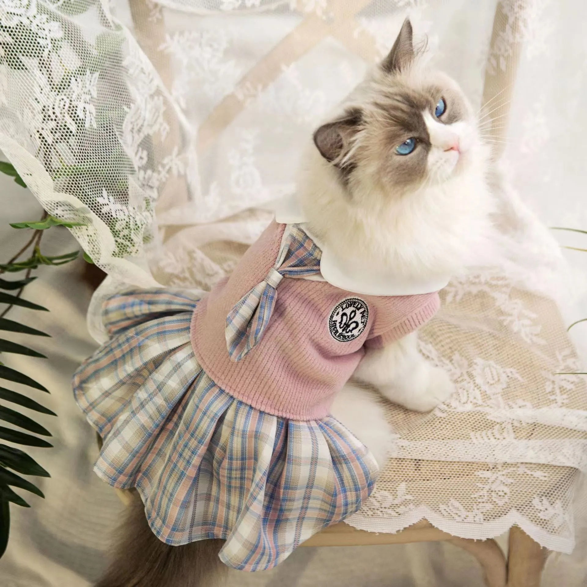 A pink tartan skirt for a small dog, showing the elastic waistband and princess-style flare.