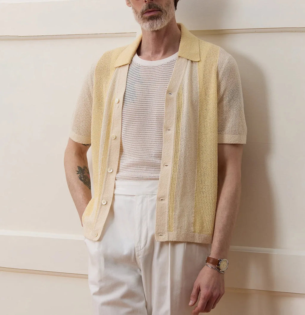 Yellow women's Tencel polo shirt with an asymmetric hemline and hollow-out detail on a short sleeve.