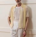 Yellow women's Tencel polo shirt with an asymmetric hemline and hollow-out detail on a short sleeve.