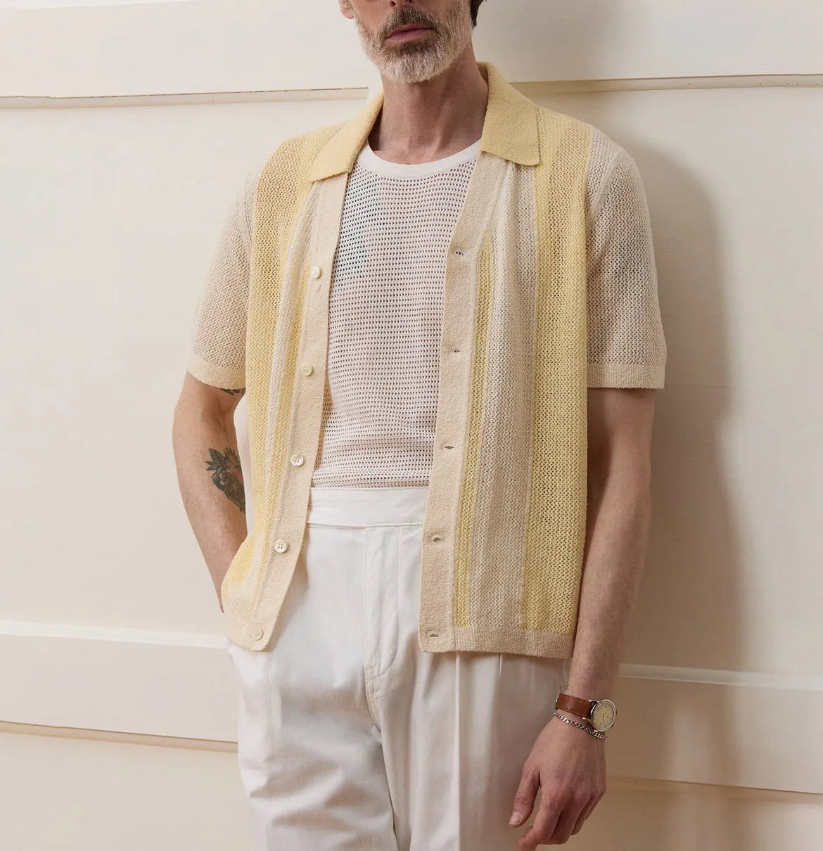 Yellow women's Tencel polo shirt with an asymmetric hemline and hollow-out detail on a short sleeve.