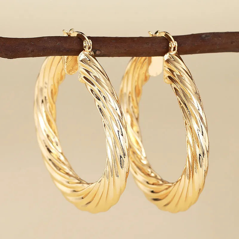 Women's geometric ring design ear clip earrings with drop-shaped elements and electroplated copper construction