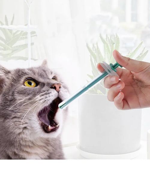 Two silicone pet pill shooter tools with soft tips for administering medication to cats and dogs.