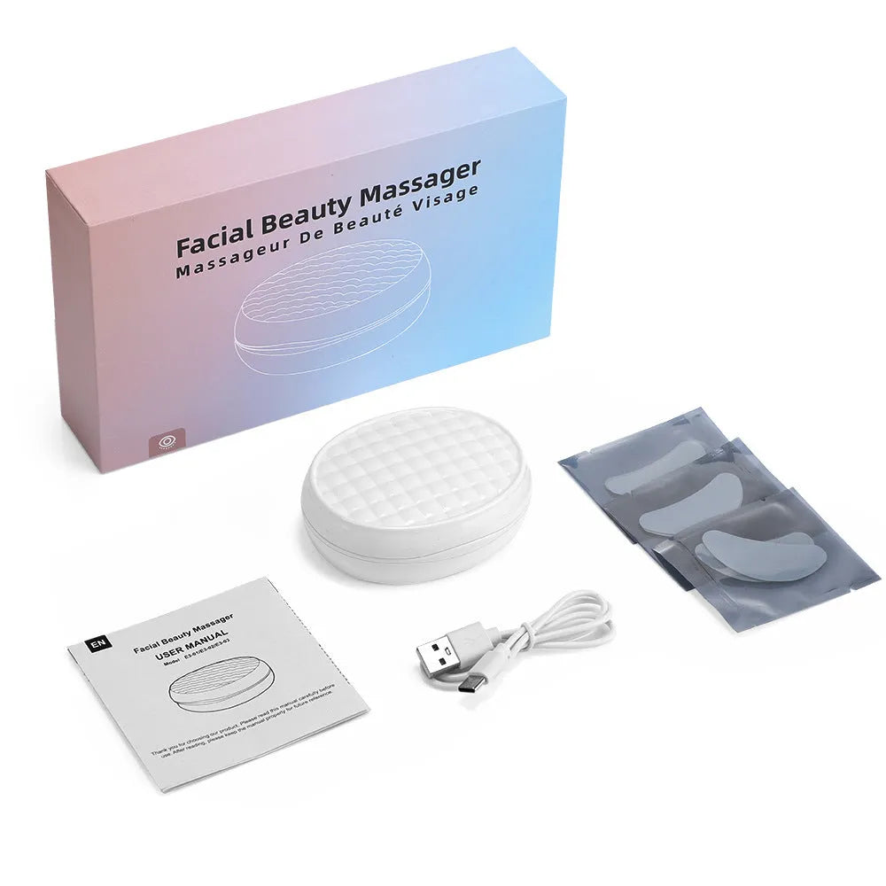 White handheld red light EMS facial and eye beauty massager device on a plain background.