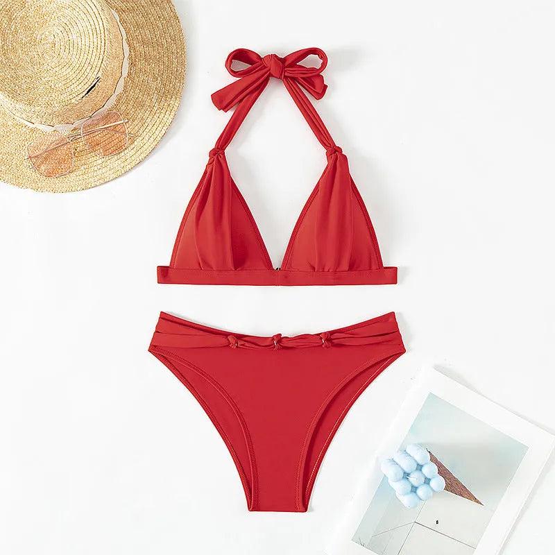 Red women's lace-up halterneck bikini set with high-cut shorts on a mannequin