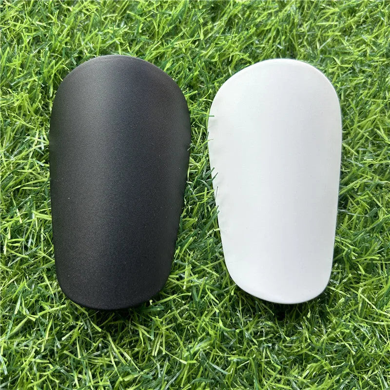 Extra small mini football shin guards plastic protection 8x5 cm black white youth