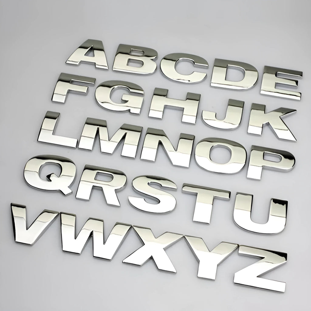 Close-up of a black metal 3D letter car sticker made from zinc alloy, showing its raised profile.