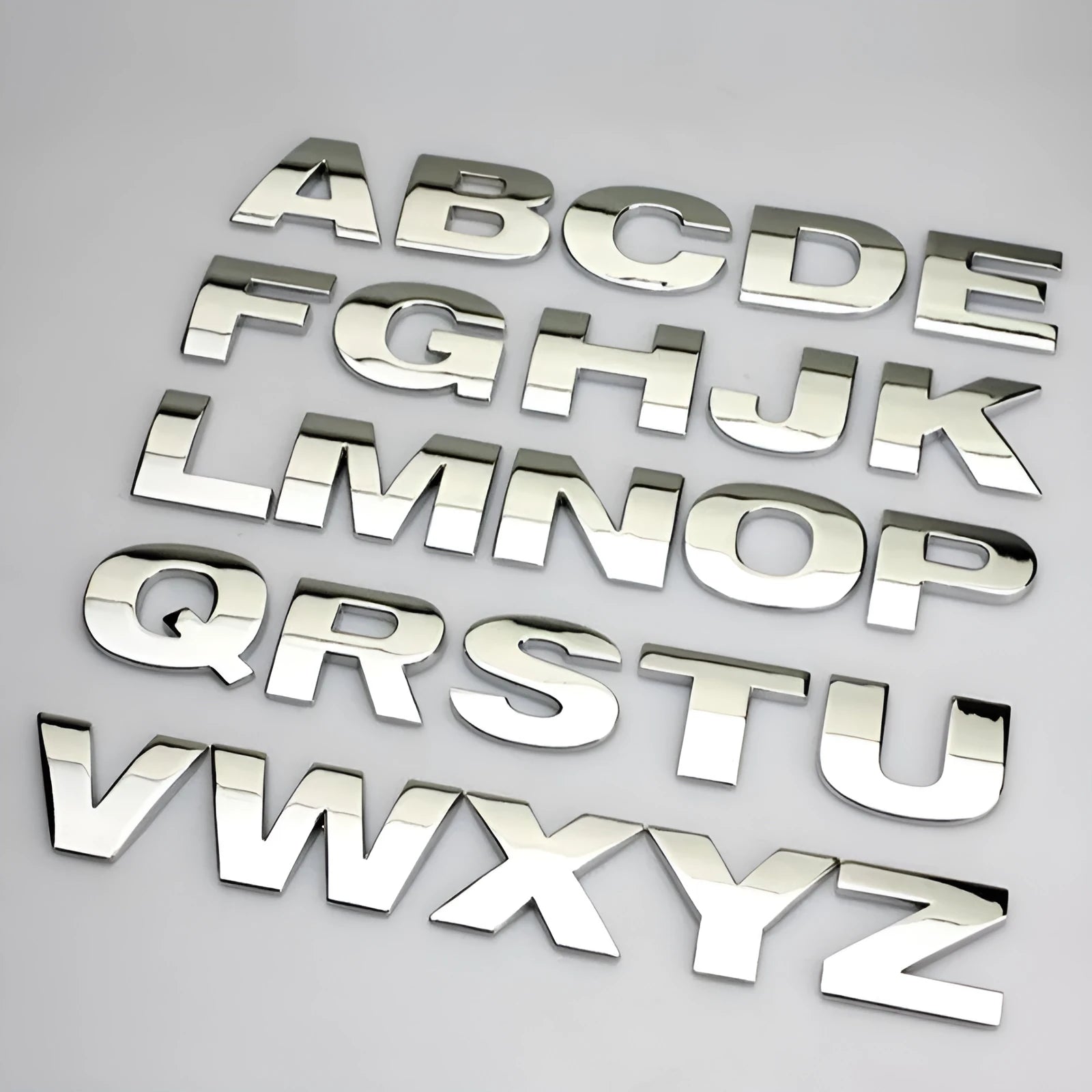 Close-up of a black metal 3D letter car sticker made from zinc alloy, showing its raised profile.