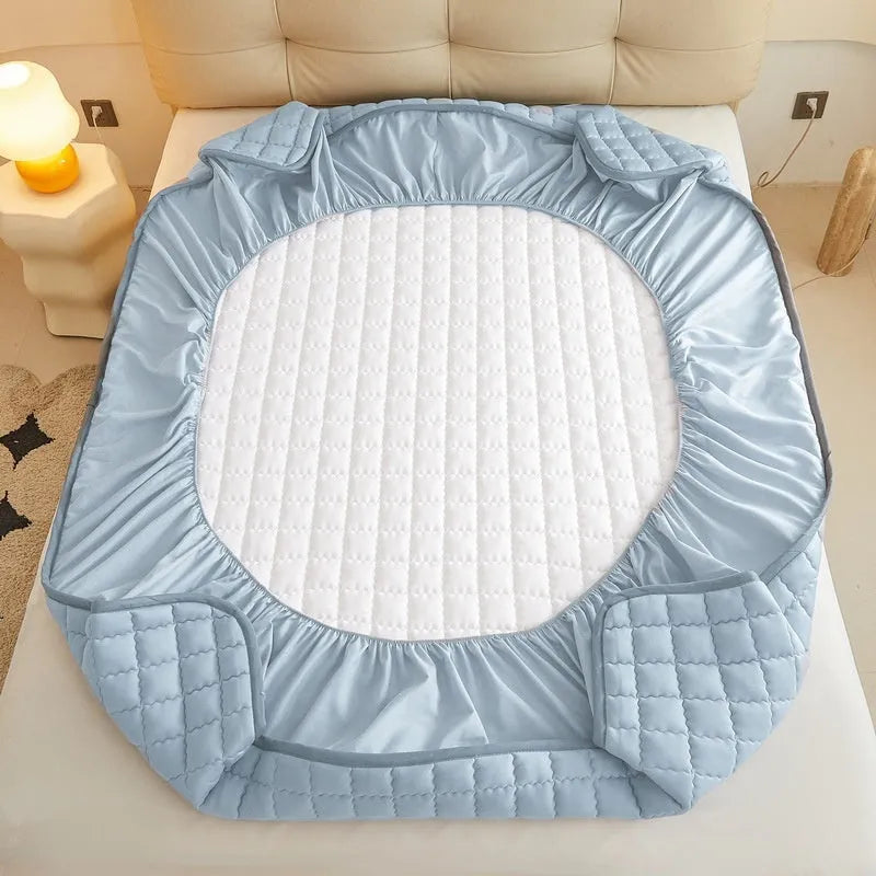 Blue waterproof washed cotton fitted sheet with elasticated edge on a mattress