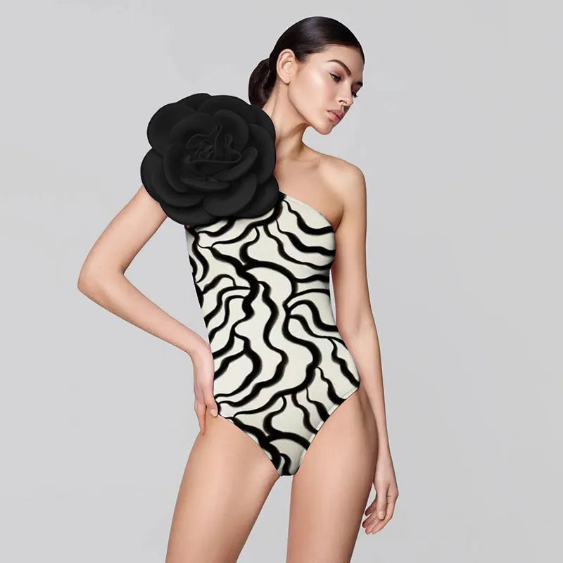 Close-up of a solid colour one-piece swimsuit with raised three-dimensional flower pattern detail