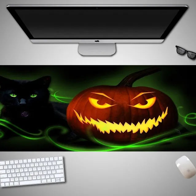 Large Halloween-themed computer mouse pad with graphic design on a desk