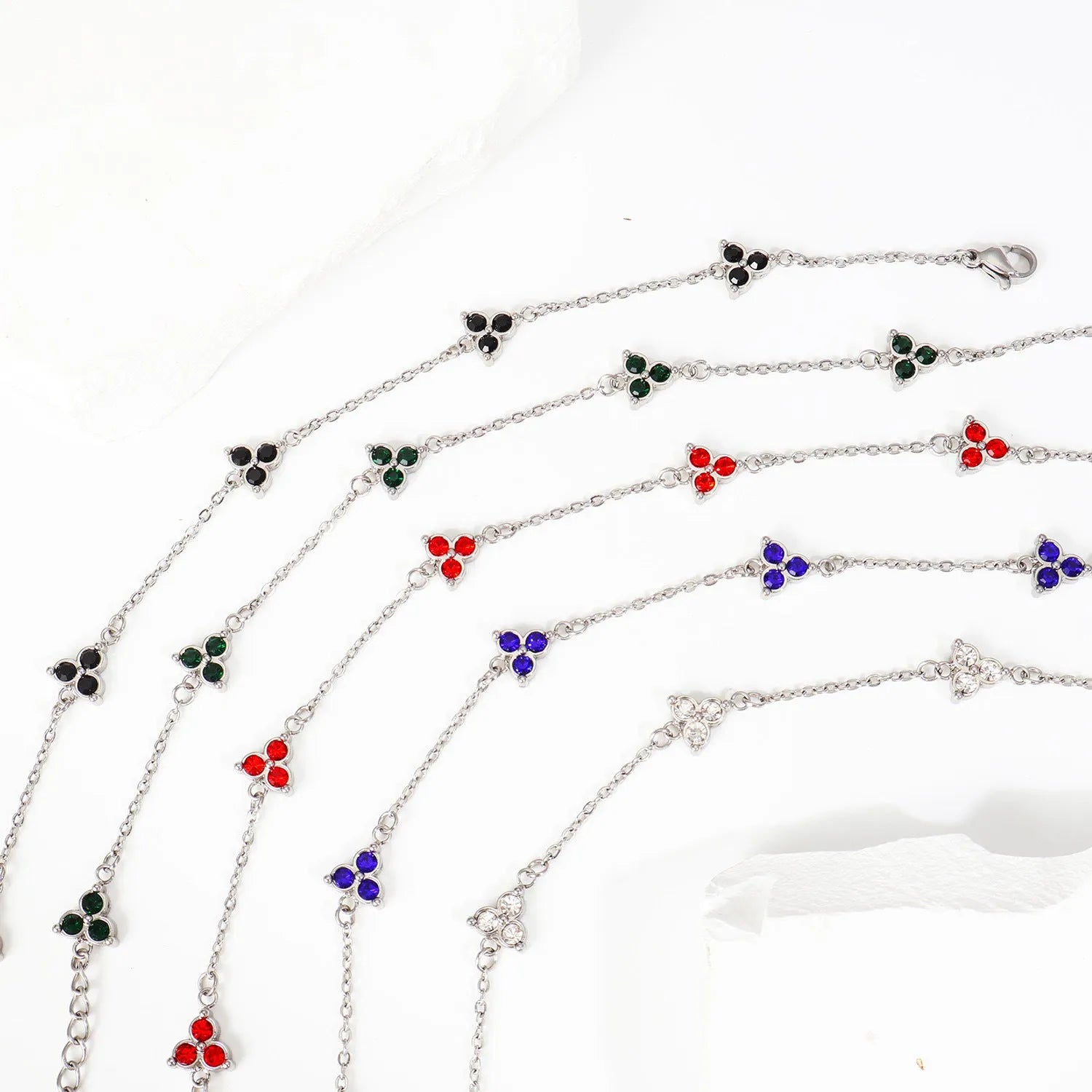 Stainless steel women's bracelet with three triangular diamond motifs set with colourful zircon stones.