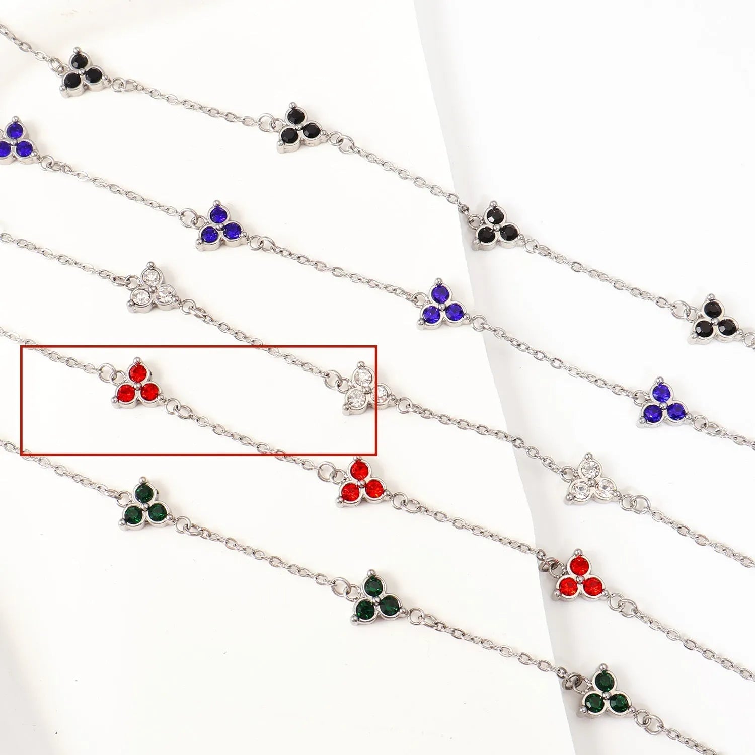 Stainless steel women's bracelet with three triangular diamond motifs set with colourful zircon stones.