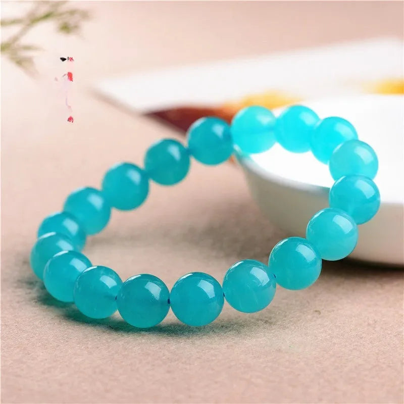 Amazonite natural scattered beads in ice colour showing polished surface and hole drilling