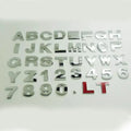 Close-up of a black metal 3D letter car sticker made from zinc alloy, showing its raised profile.