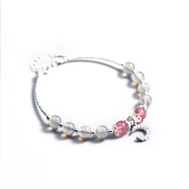 Natural moonstone handmade bracelet with crescent moon charm on wrist showing adjustable clasp