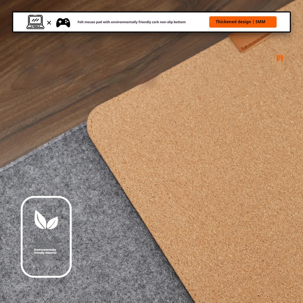 Oversized grey felt and cork desk mouse mat shown on a wooden desk with keyboard and mouse.