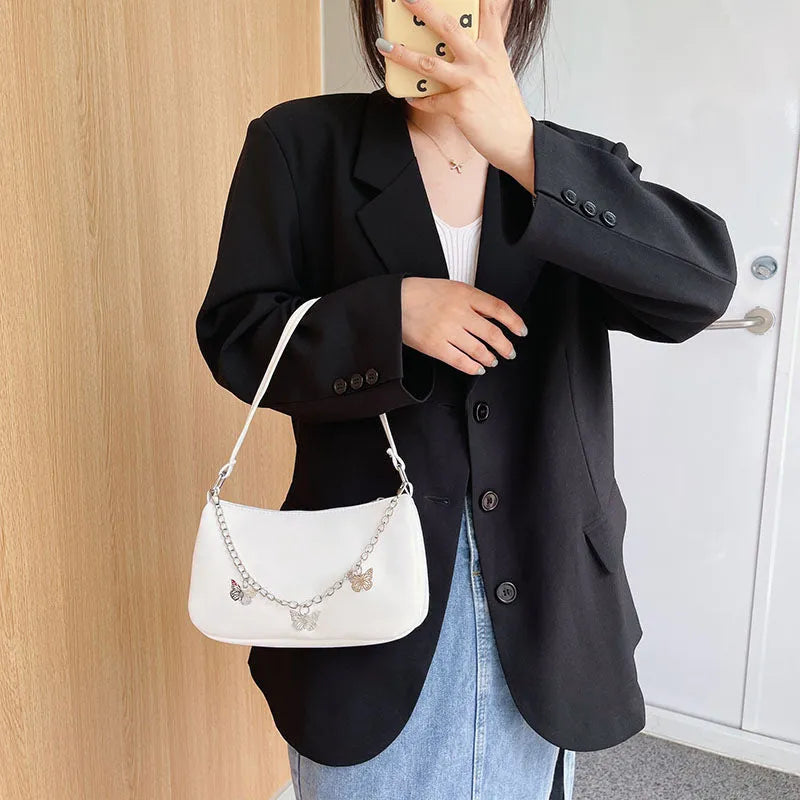 Women's black PU butterfly chain underarm handbag with crossbody strap, shown in a horizontal square shape.