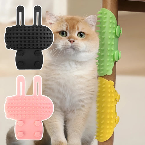 Silicone cat grooming comb with adjustable strap mounted on a table leg, shown in assorted colours.