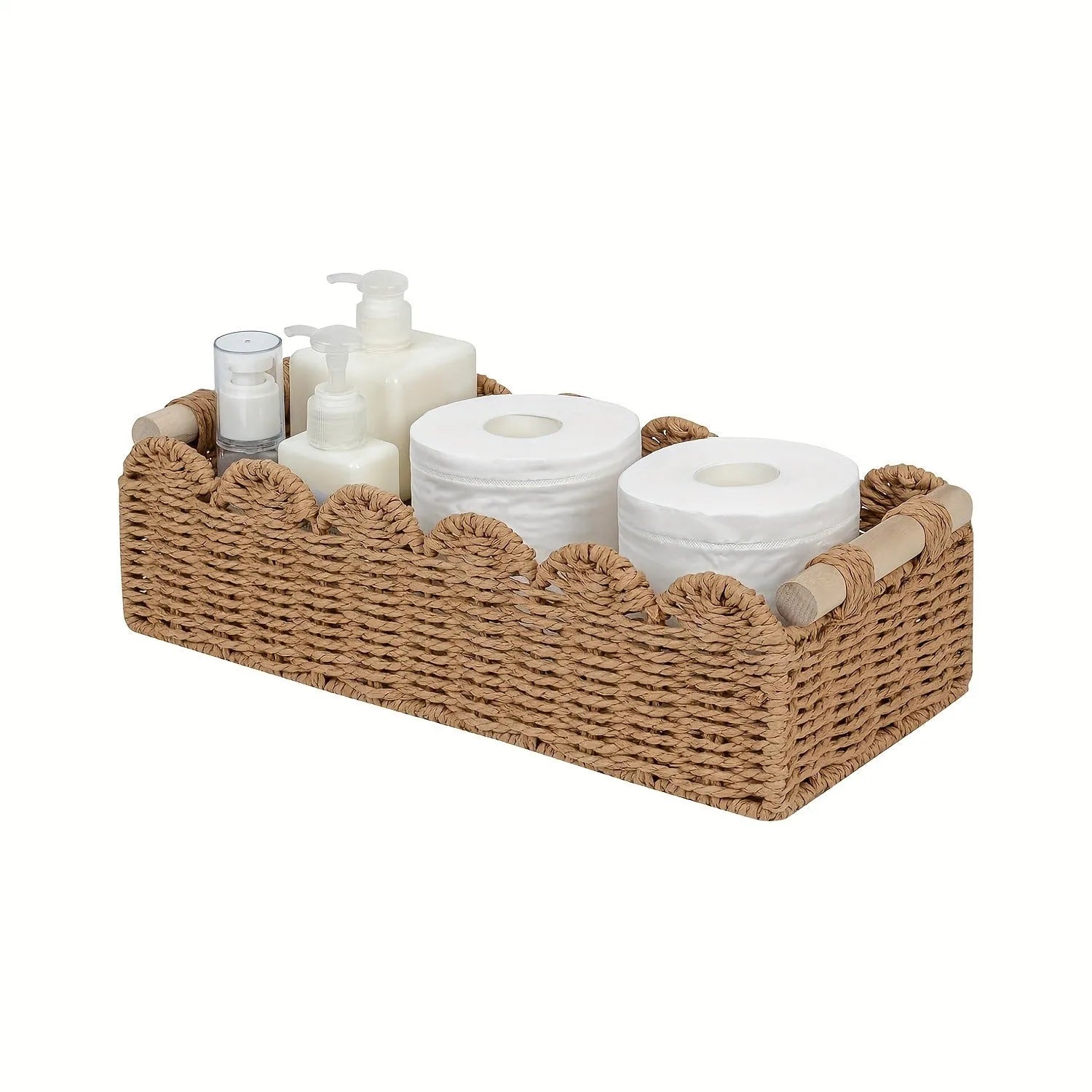 Woven paper storage basket in khaki colour on a desktop, holding remote controls and stationery.