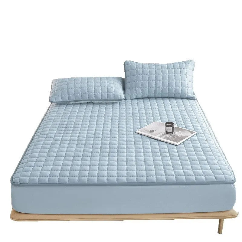 Blue waterproof washed cotton fitted sheet with elasticated edge on a mattress