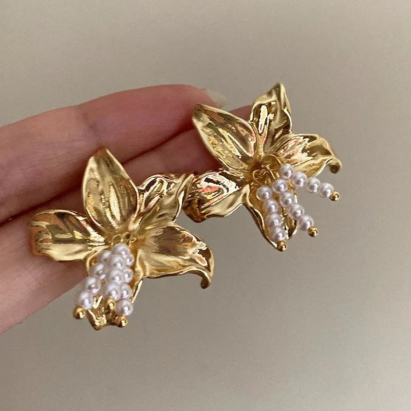 Golden H1795 metal earrings with detailed flower shape and exaggerated design elements