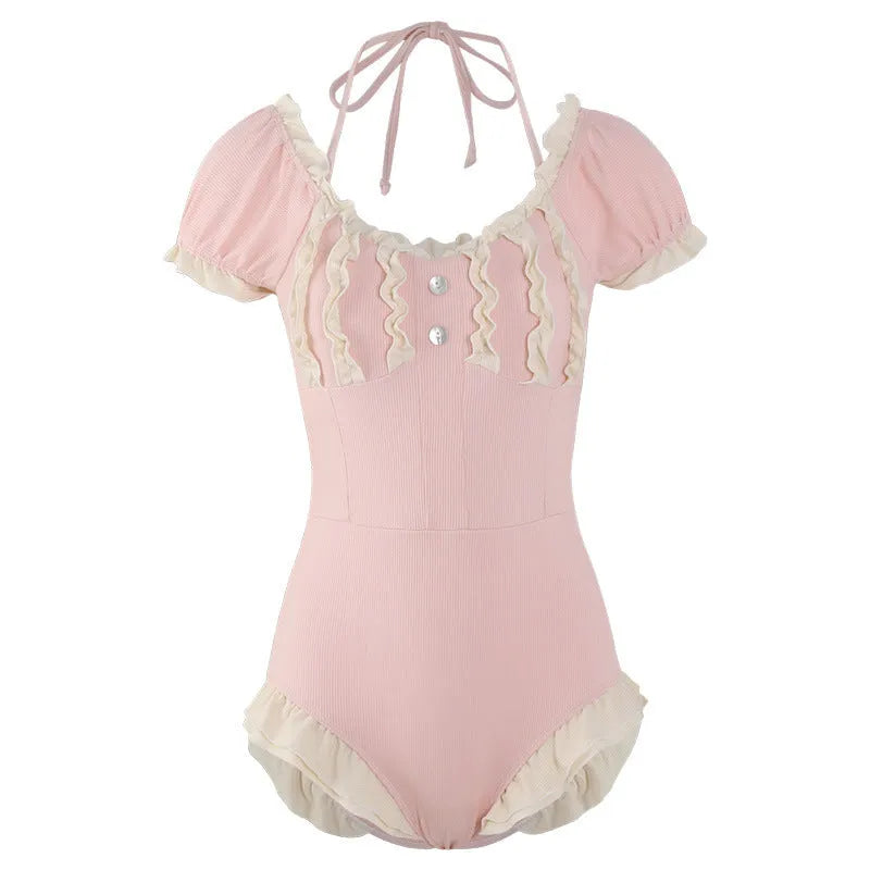 Pink women's conservative one-piece swimsuit made from nylon fabric on a mannequin.