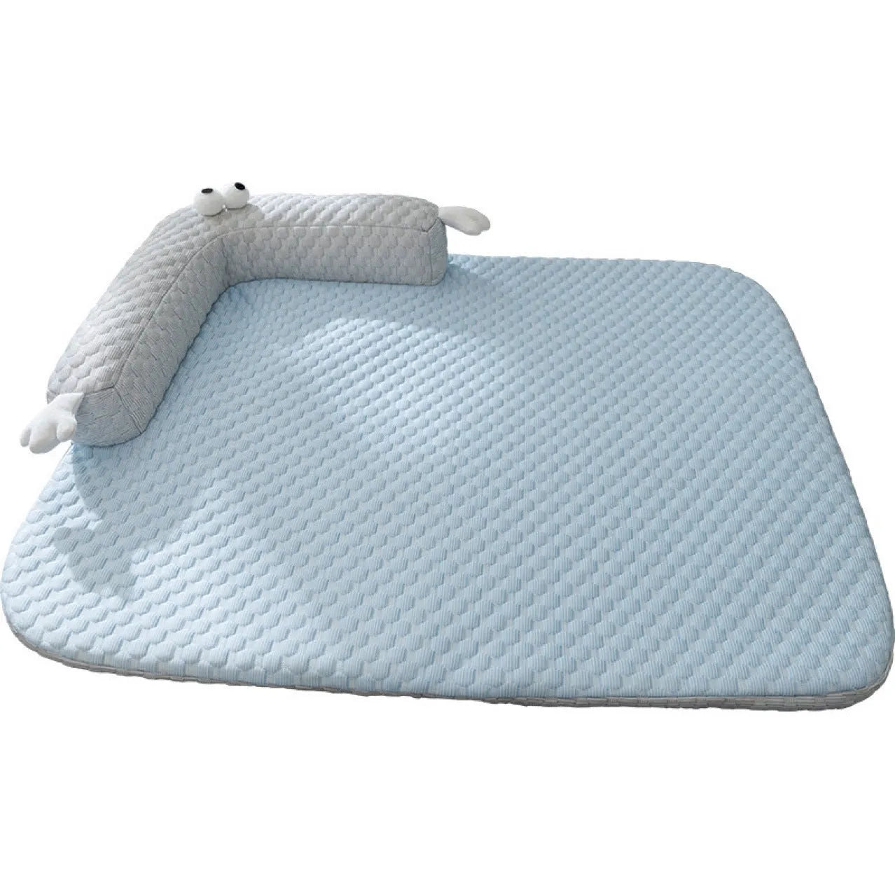 Blue pet bed cushion with a big-eyed monster design on a wooden floor.
