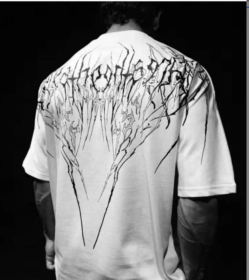A man's loose-fit dark coloured cotton t-shirt with a gold gilding design detail on the front.