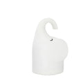 DOMI soft silicone elephant night light on a bedside table emitting warm white glow