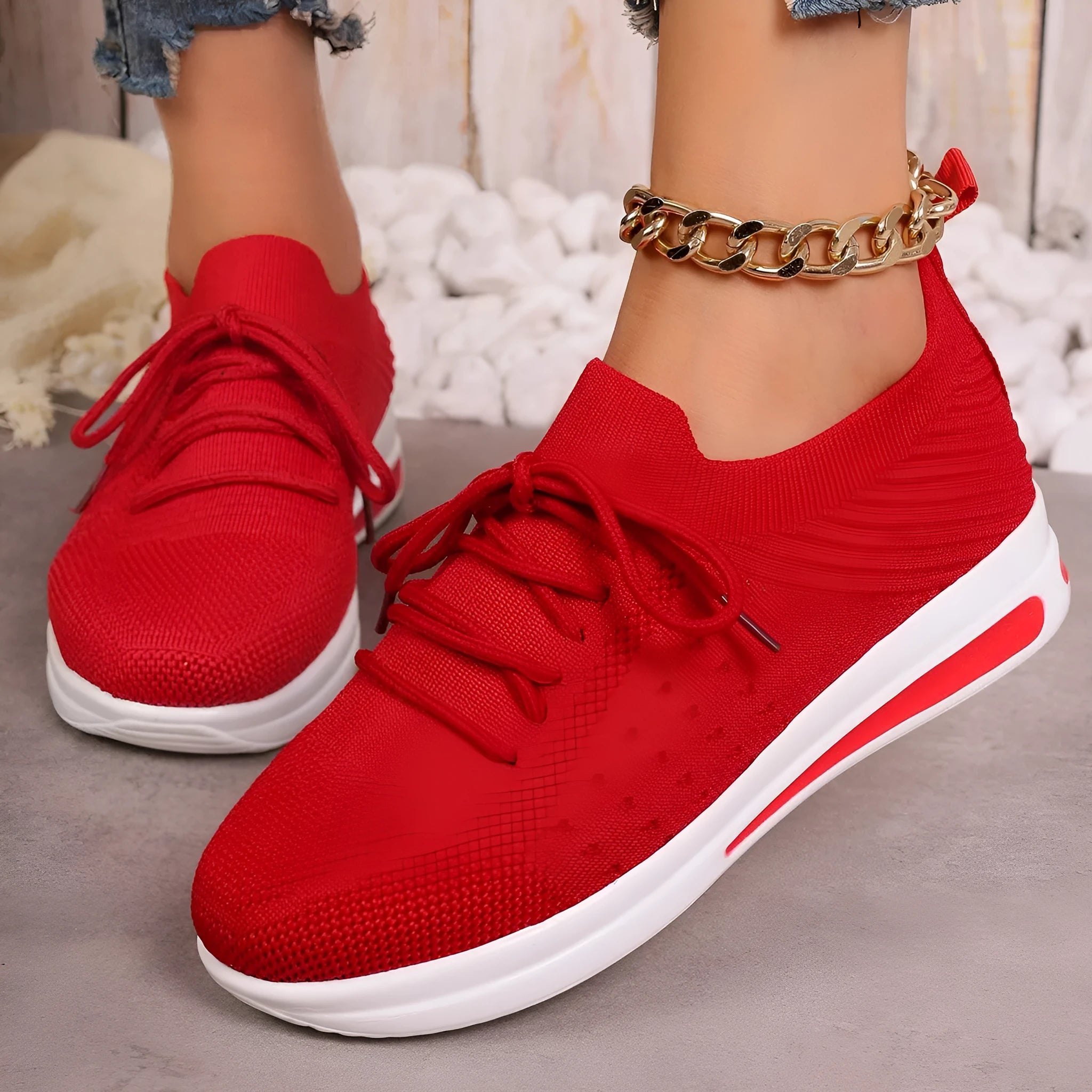 Women's black fly-knit casual sneakers with lace-up front and low-top design on a white background