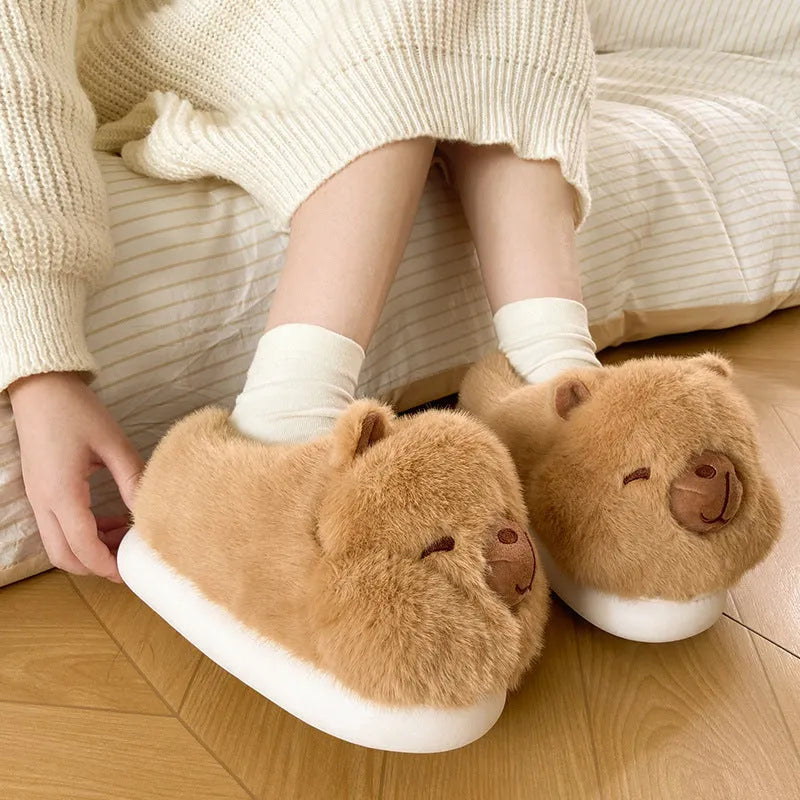 Light brown women's plush winter slippers with cartoon pattern and oversleeve design.