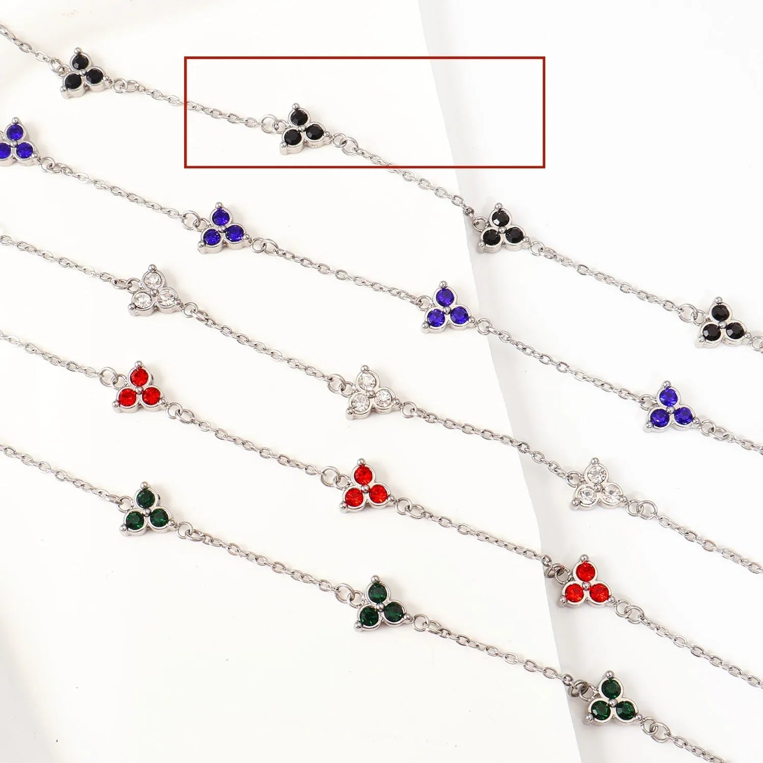 Stainless steel women's bracelet with three triangular diamond motifs set with colourful zircon stones.