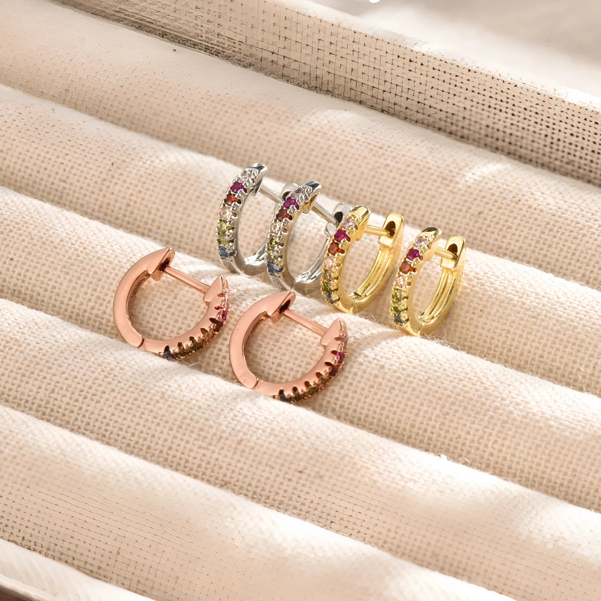 Copper U-shaped ear cuff with round zircon inlay in gold finish on earlobe