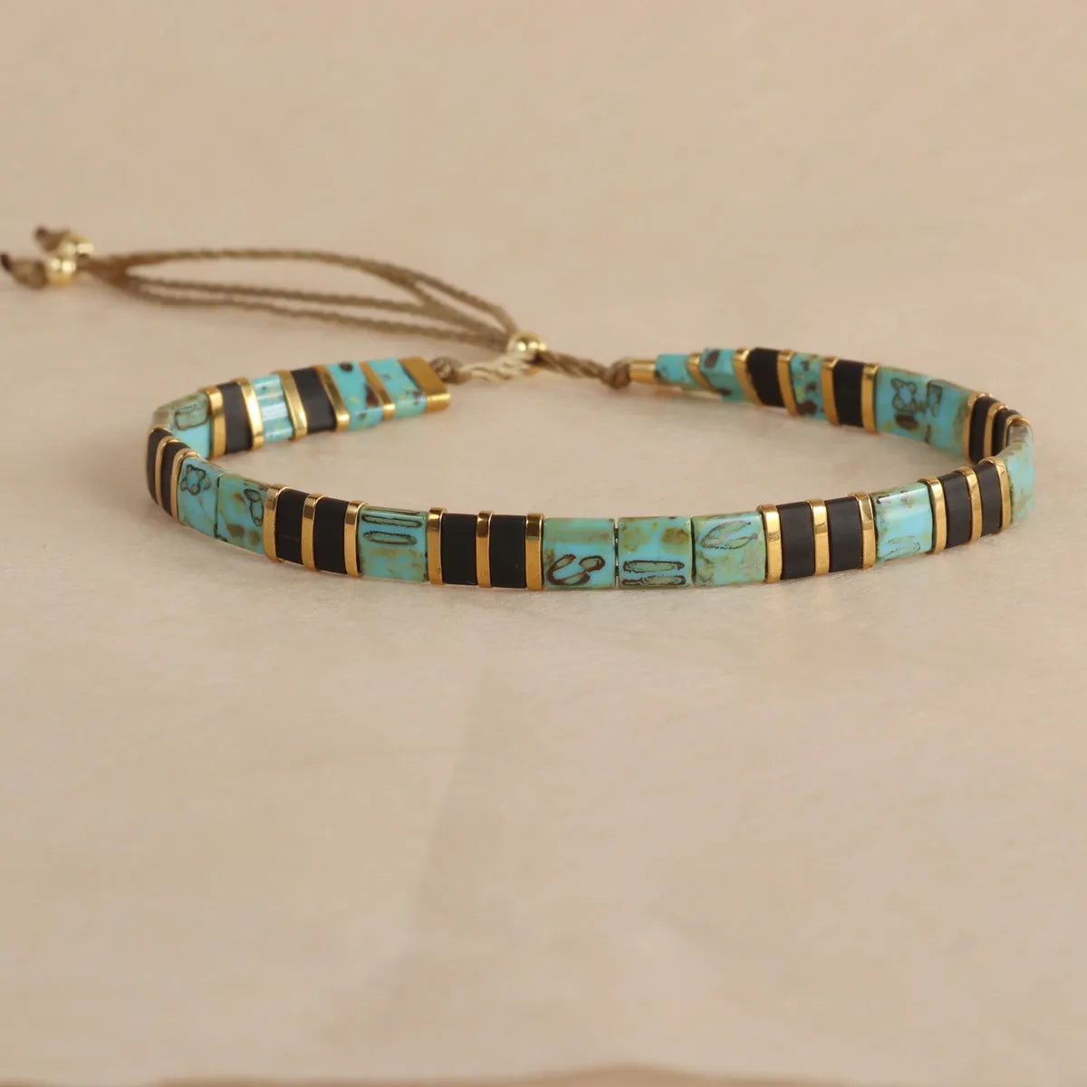 Geometric glass and coloured glaze bead bracelet in milky white, black, green, blue, or red