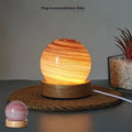 Planets themed USB night light with modern design and three-colour dimming on bedside table.