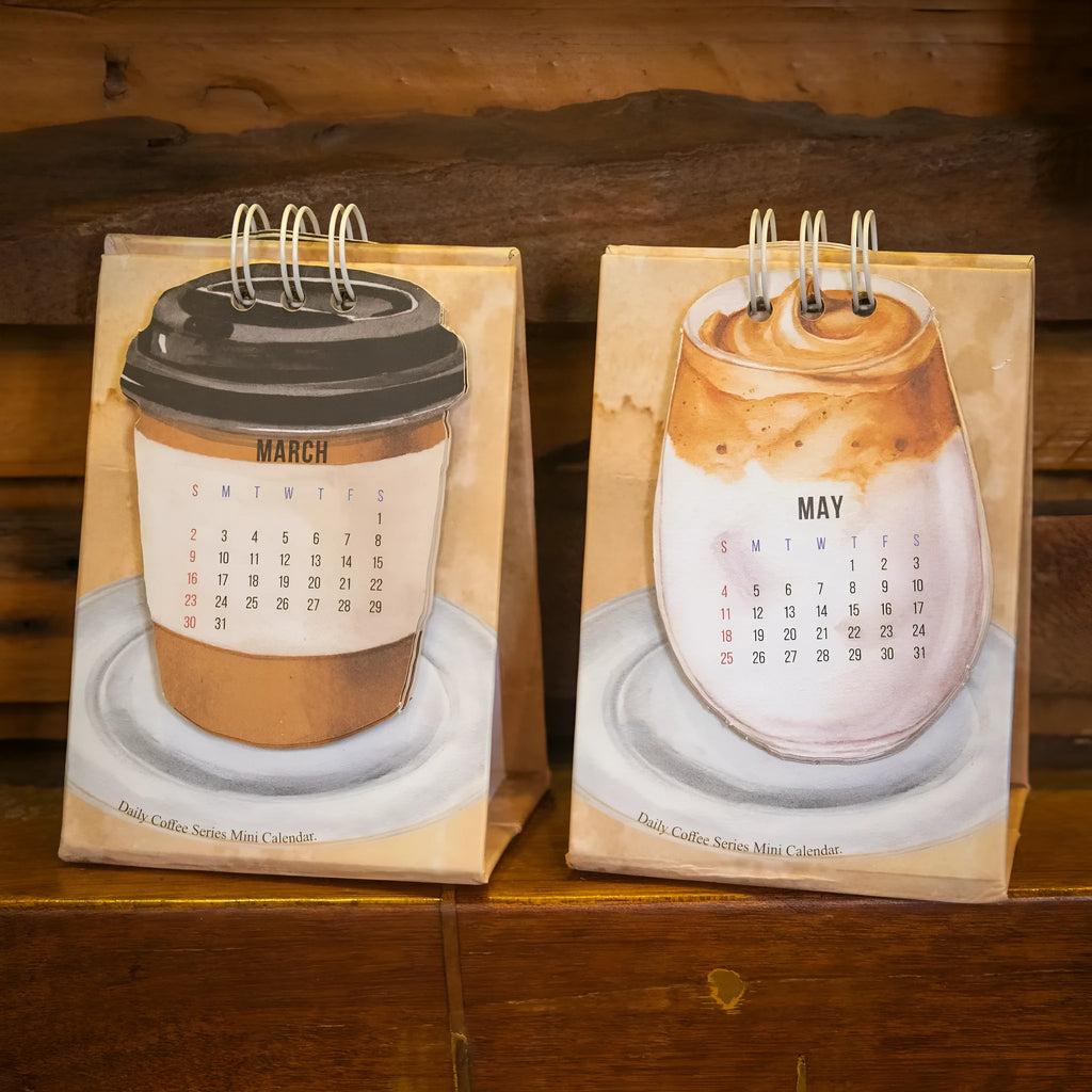 Mini 2025 desk calendar in a simple modern design on a wooden desk