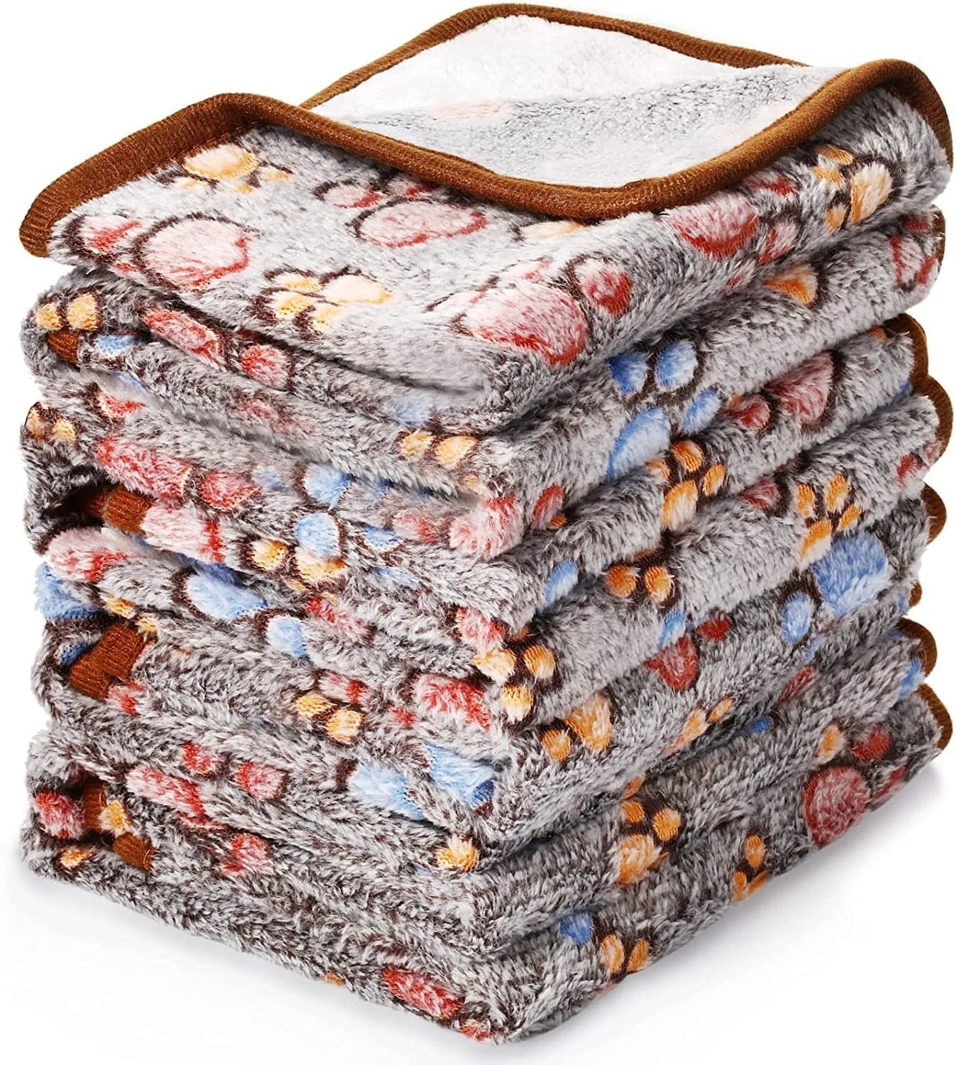 Coral fleece dog blanket with paw print design, shown in camel colour, laid flat.