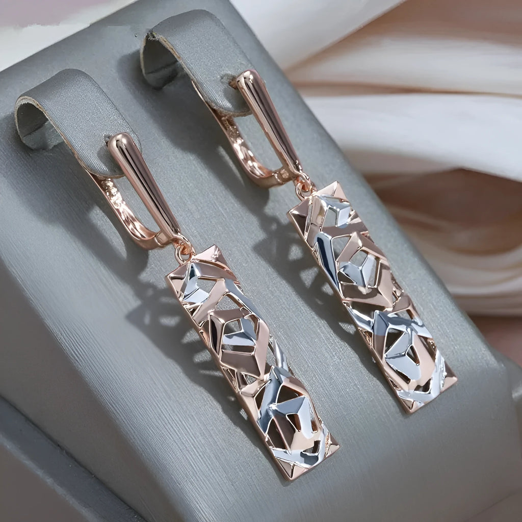 A pair of rectangular hollow geometric stud earrings with a two-tone colour finish on alloy posts.