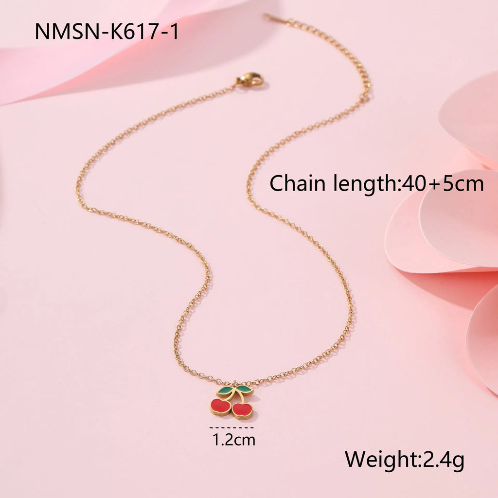 Cherry-themed jewellery set showing stainless steel necklace, bracelet, earrings, and ring with 18K gold plating.
