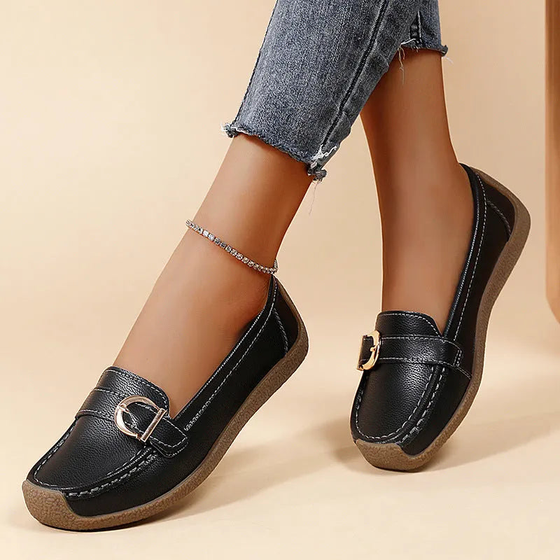 Women's beige loafers with round toe and flat heel on a light background