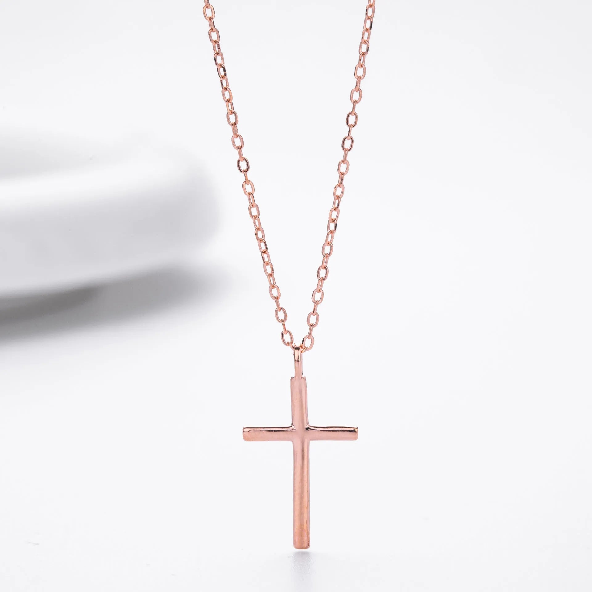 S925 sterling silver necklace showing simple glossy cross pendant on O-shaped chain in gold plating