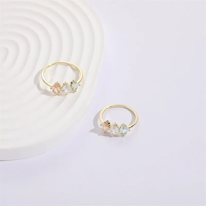 Geometric triangle women's ring with tricolor zircon horse eye design in electroplated gold.
