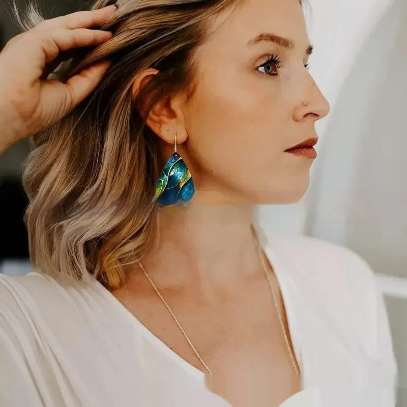 Clear acrylic drop earrings with flat branch knot design, front view