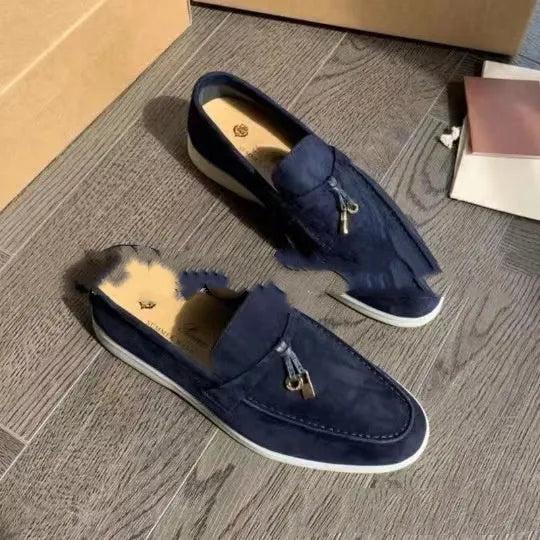 Unisex high-top slip-on loafers with a round toe cap and rubber sole on a neutral background.