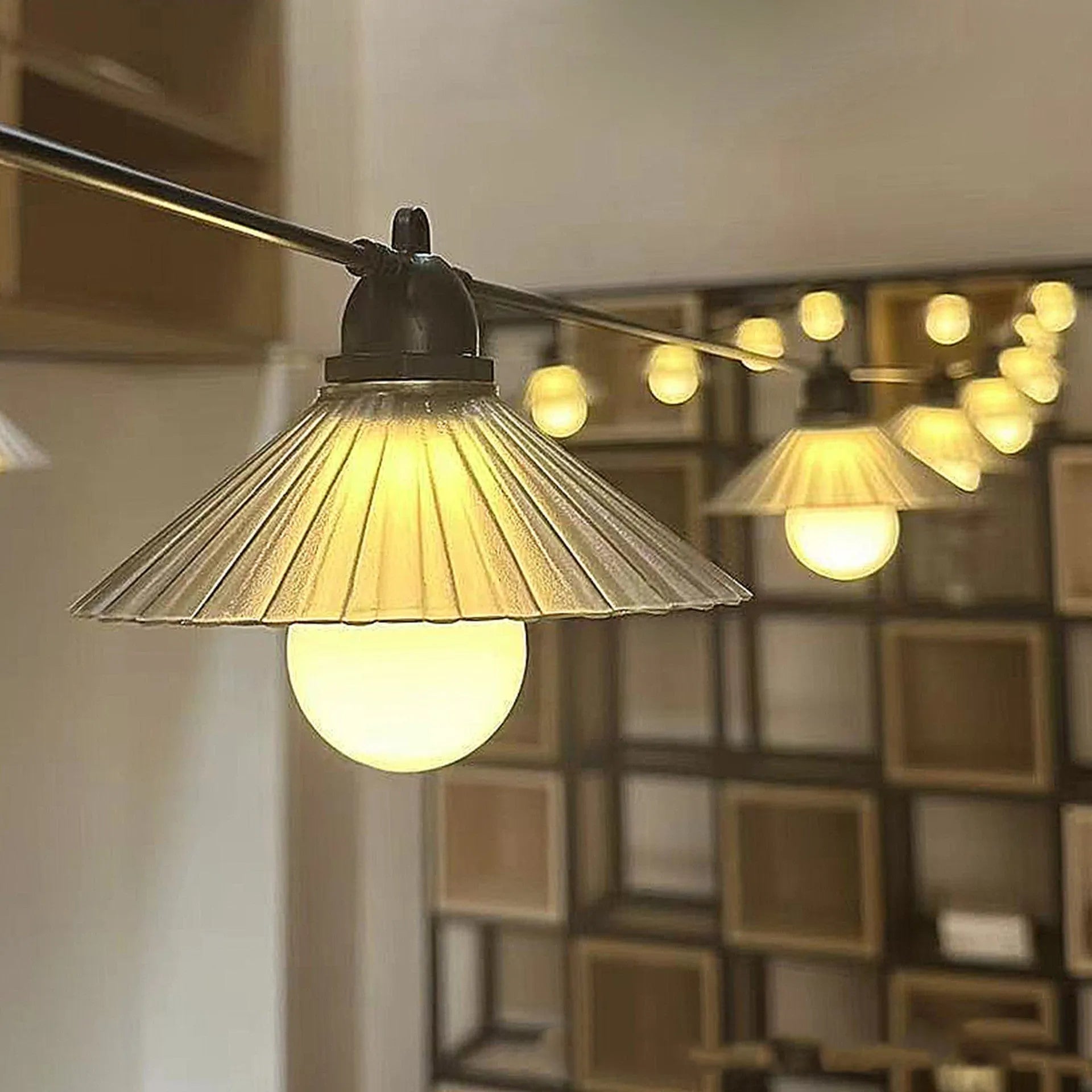 Outdoor LED string lights with flower-shaped globes in various colours including warm white