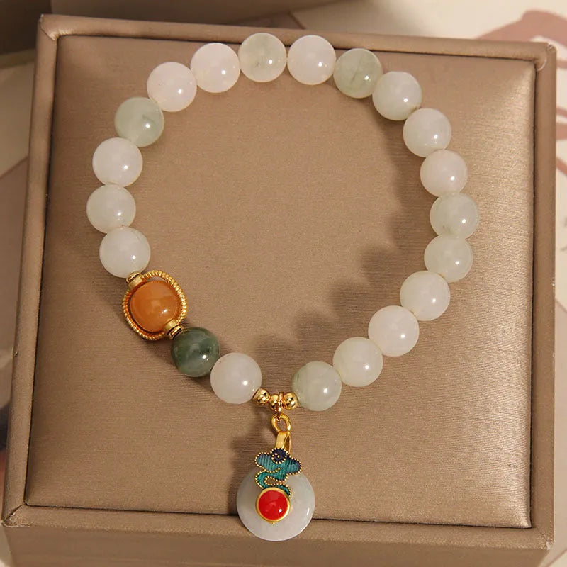 Women's ice jade crystal bracelet with pearl accents and a jade buckle on a white background.