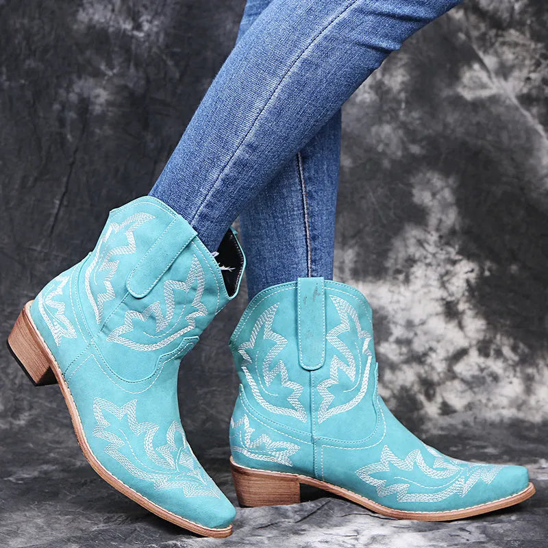 Blue women's cowboy ankle boots with embroidery, a pointed toe, and a low wedge heel.
